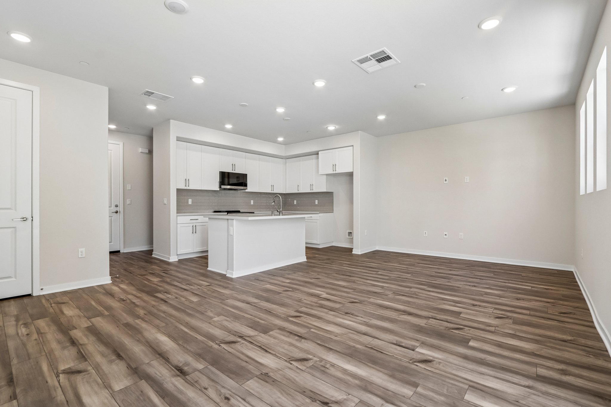 A large kitchen with white cabinets.