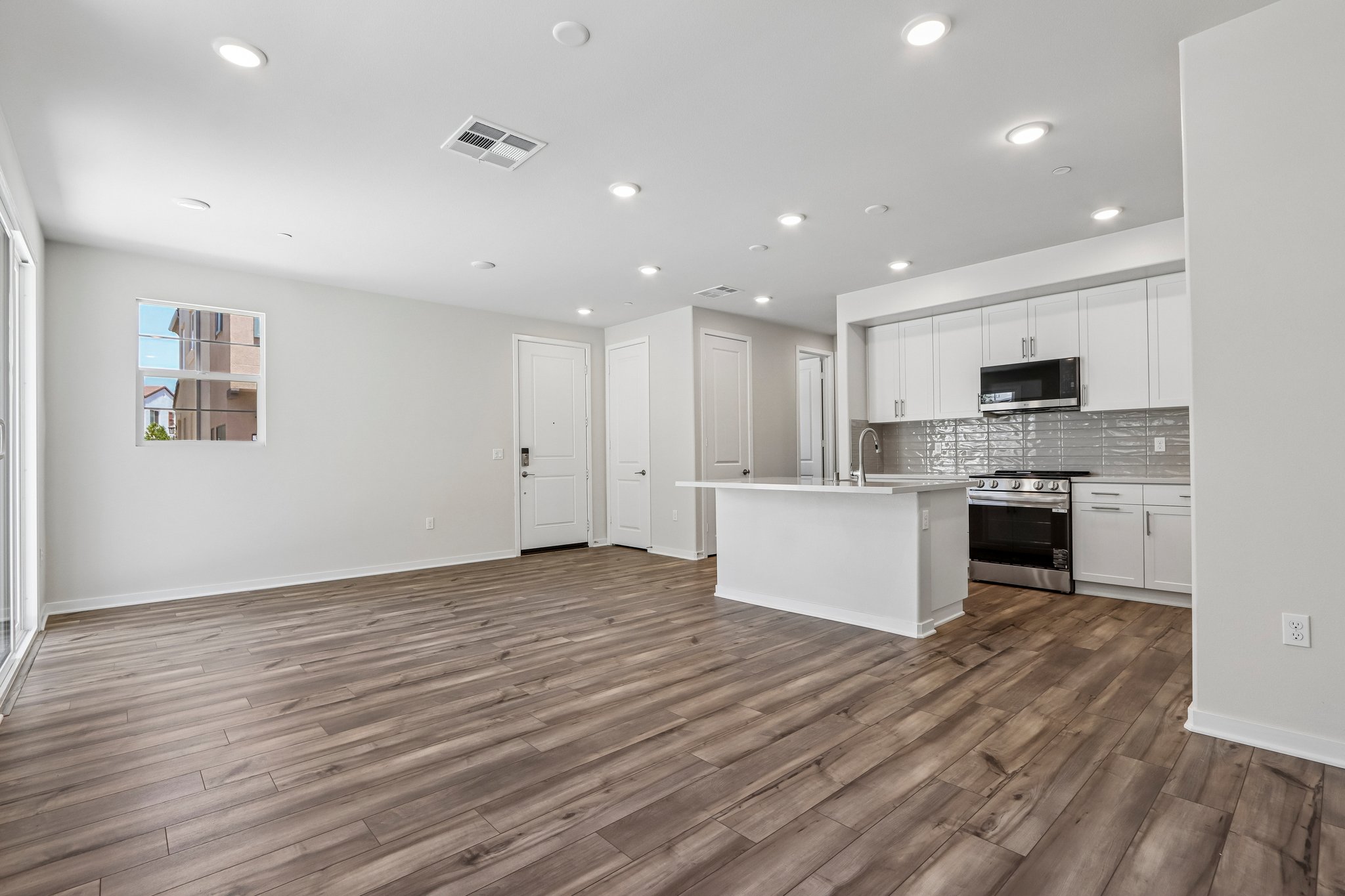 A large kitchen with white cabinets.
