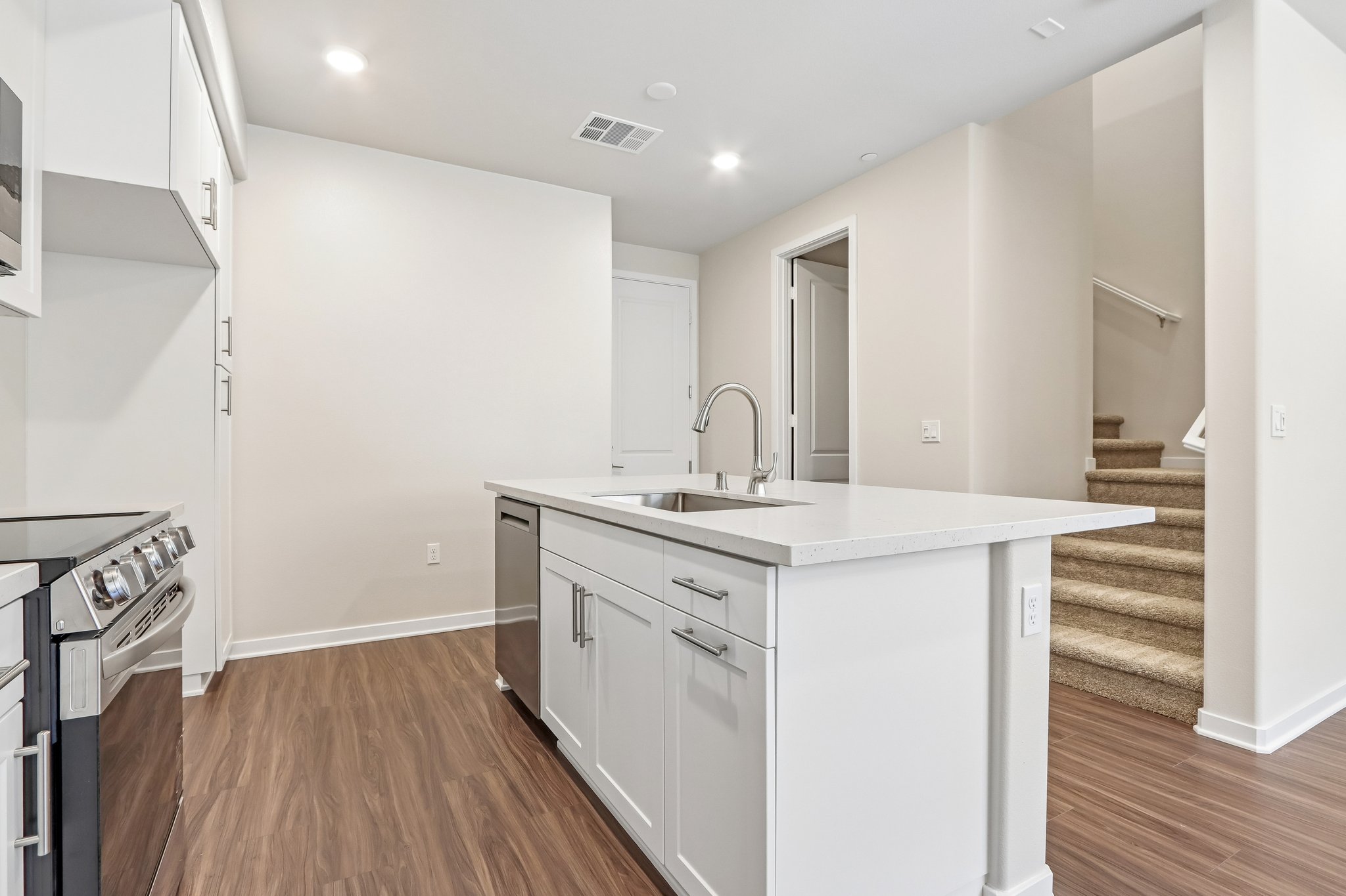 A kitchen with white cabinets.