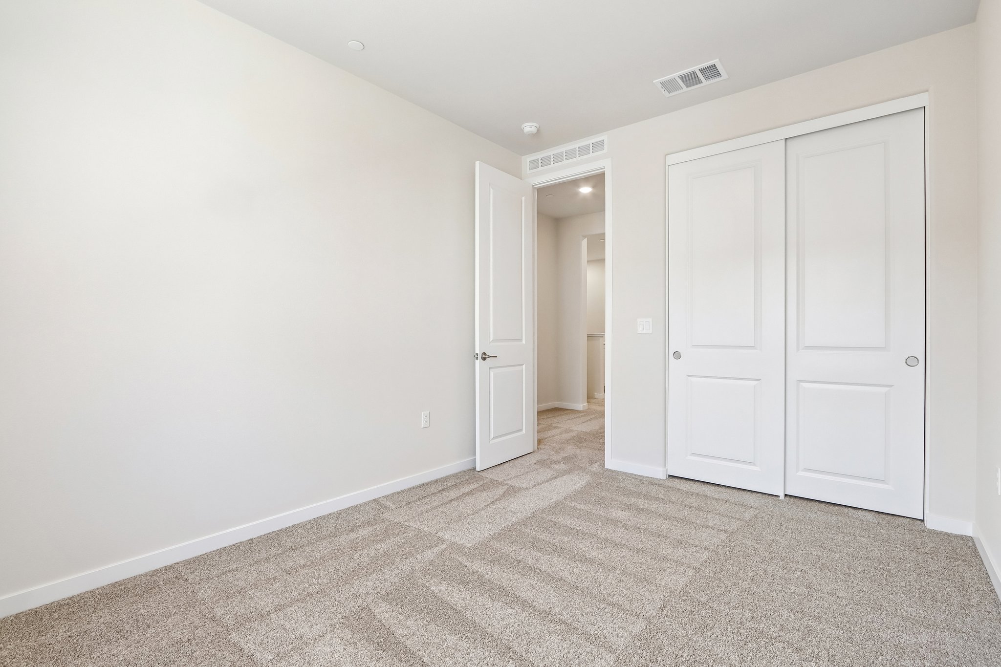 A hallway with white doors.