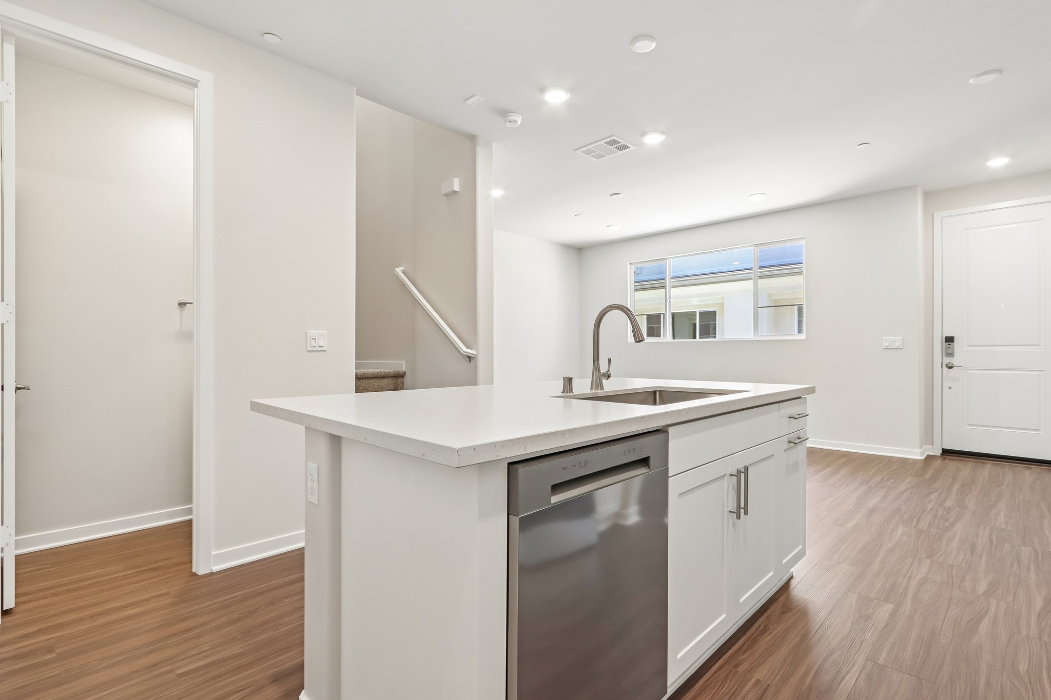 A kitchen with white cabinets.