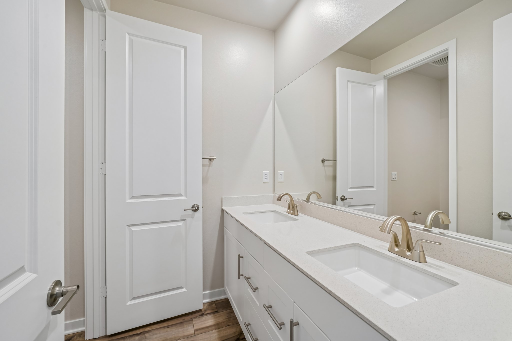 A bathroom with a large mirror.