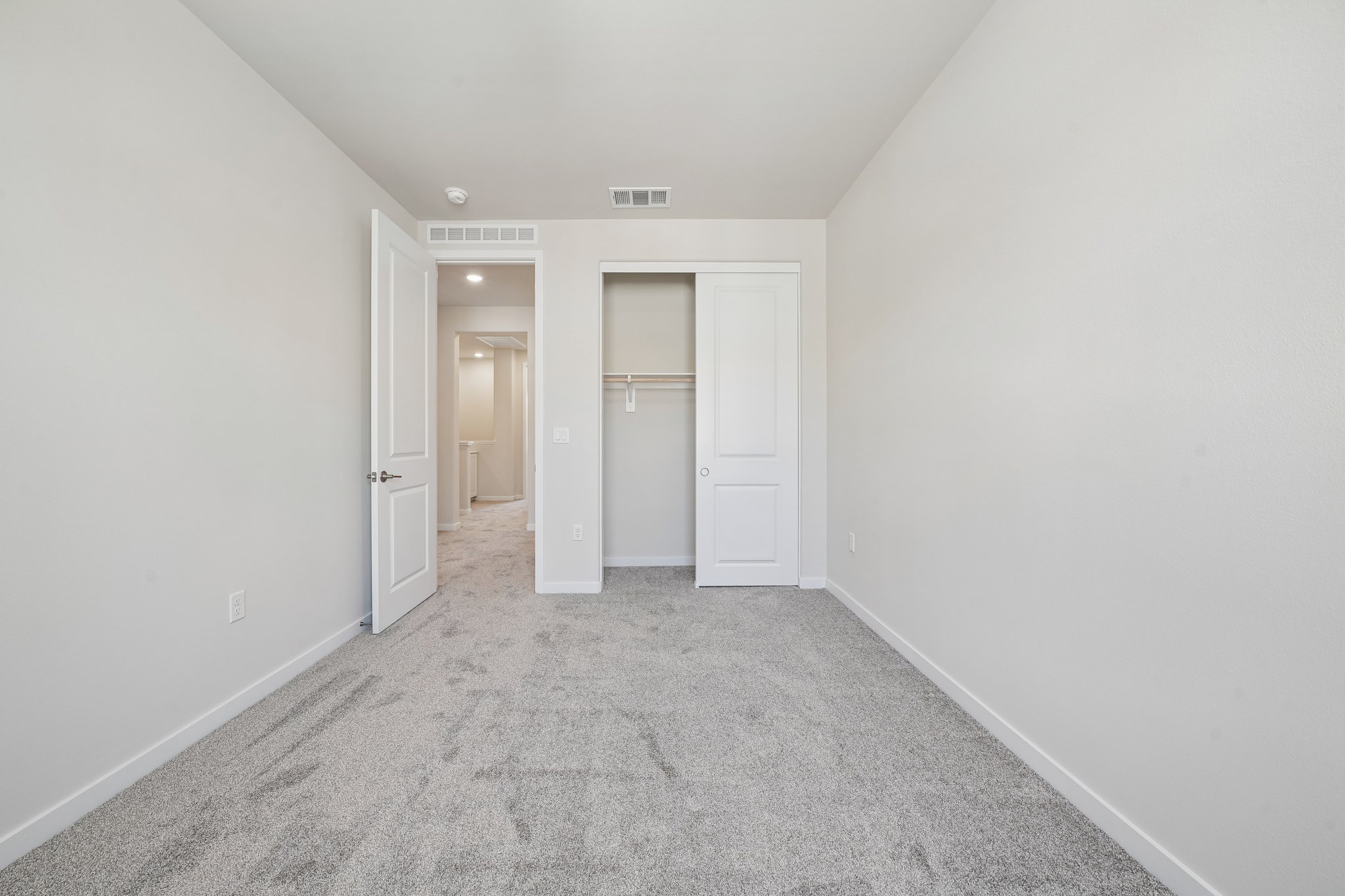 A hallway with white doors.