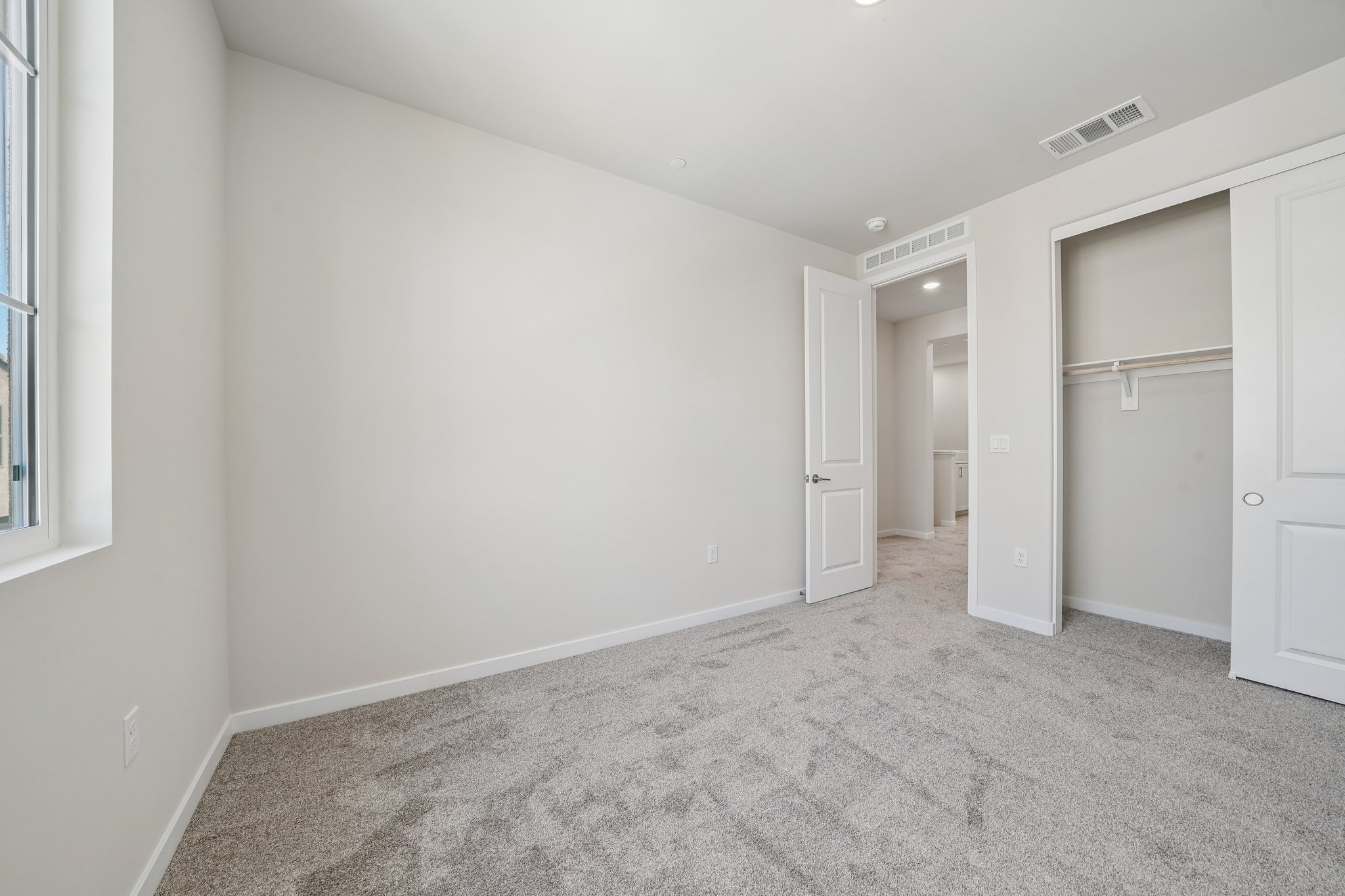 A hallway with white doors.