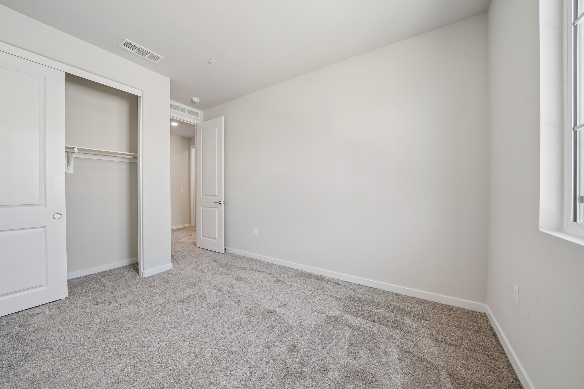 A hallway with white doors.