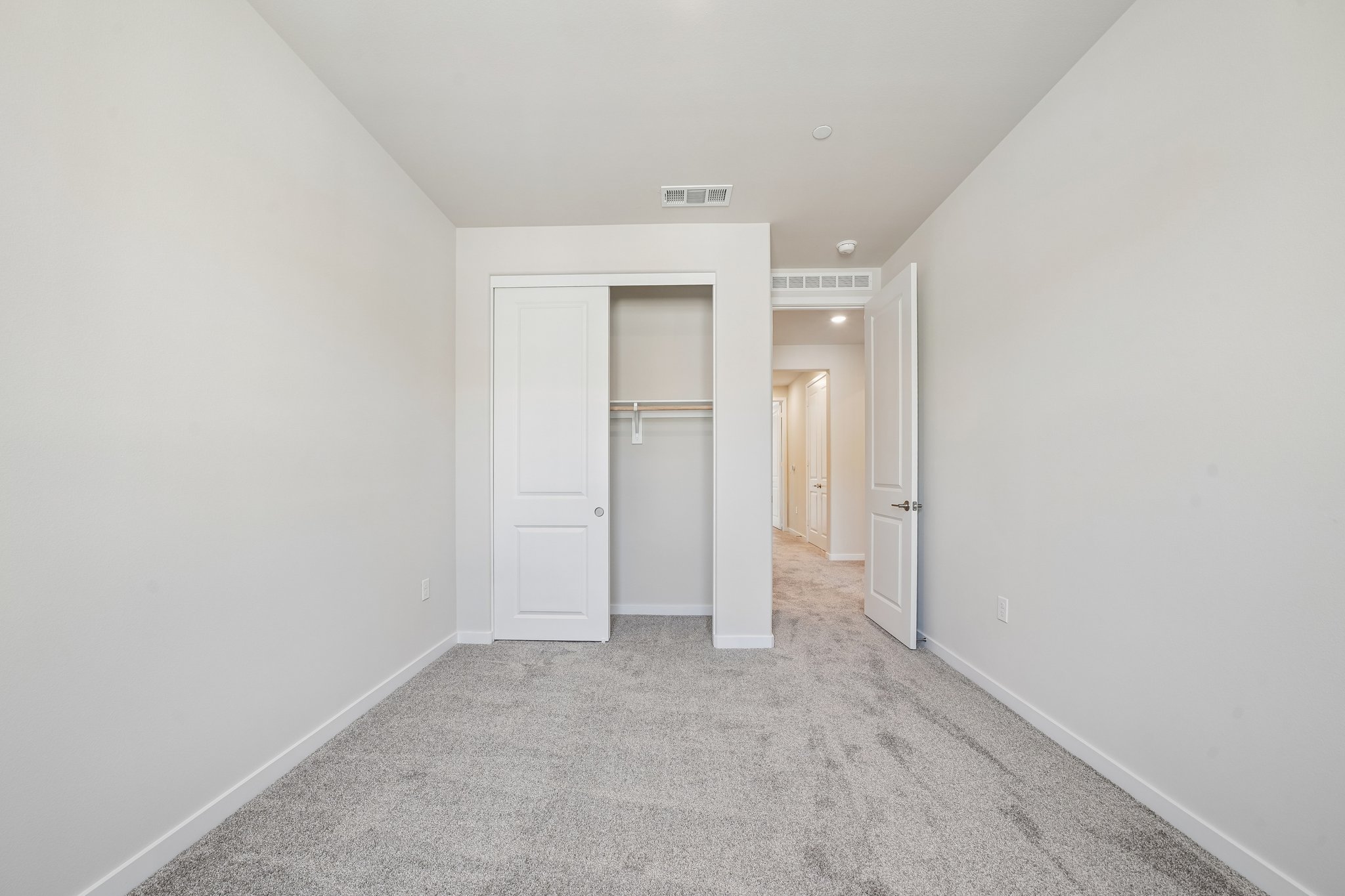 A hallway with white doors.