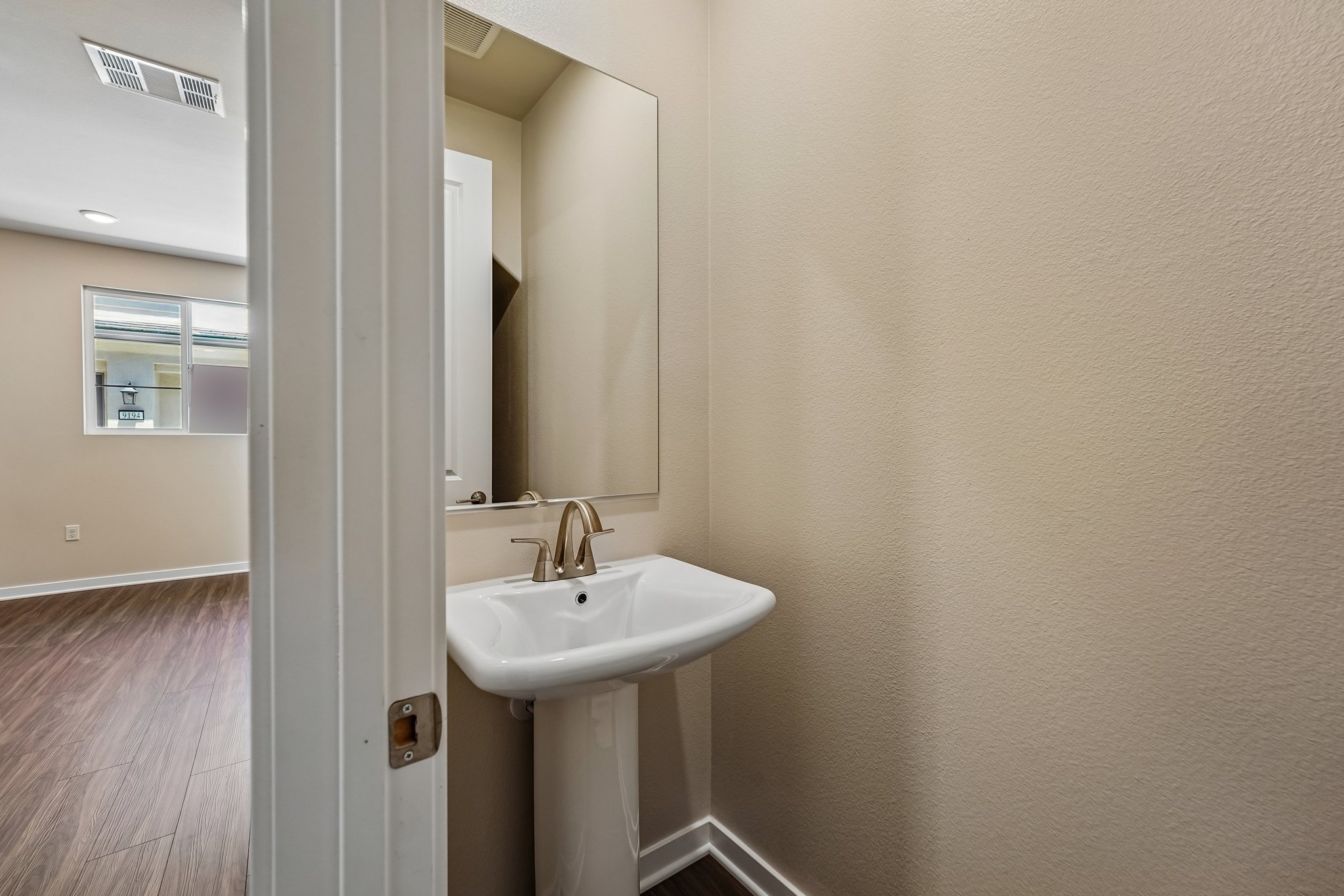 A bathroom with a sink and mirror.
