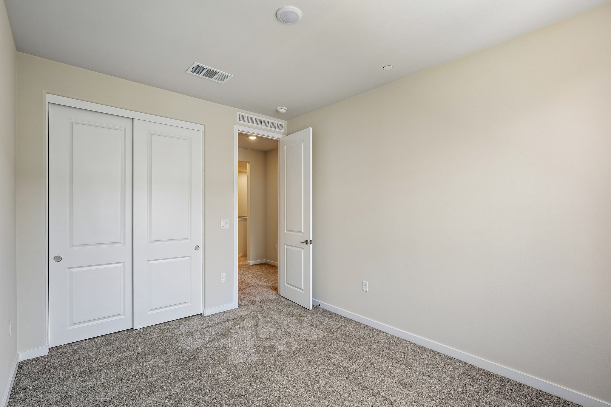 A hallway with white doors.
