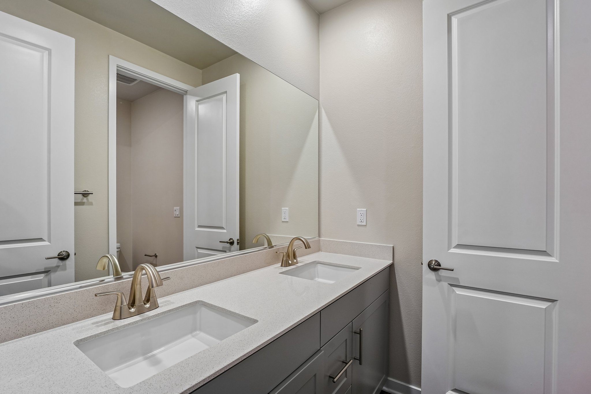 A bathroom with a large mirror.