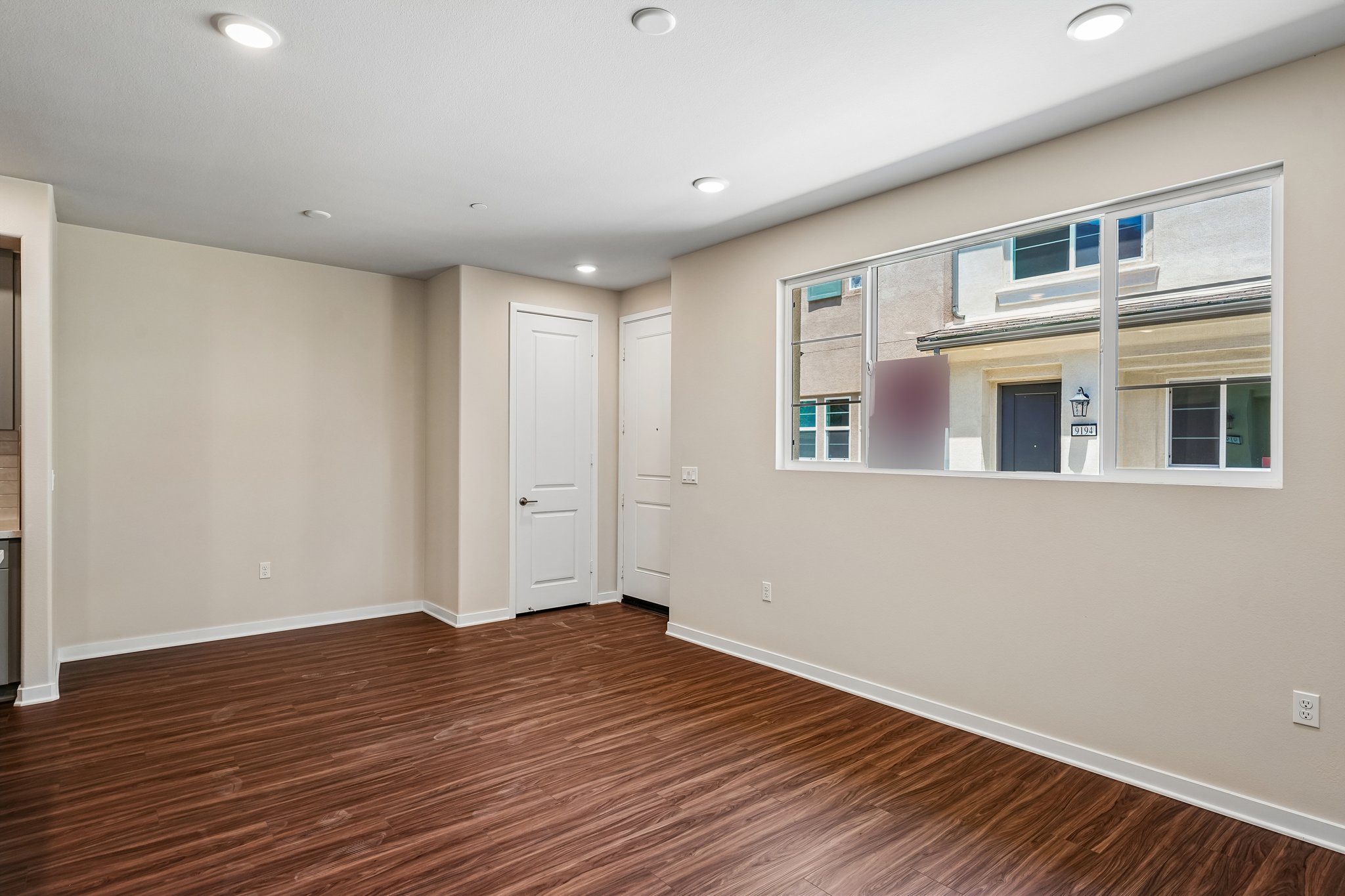 A room with a wood floor and a window.