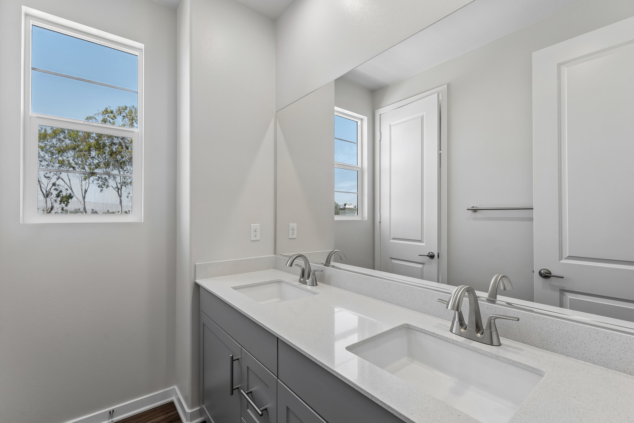 A bathroom with a large mirror.