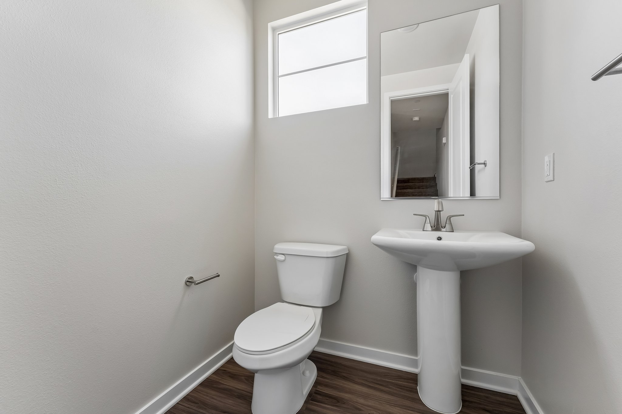 A bathroom with a toilet and sink.