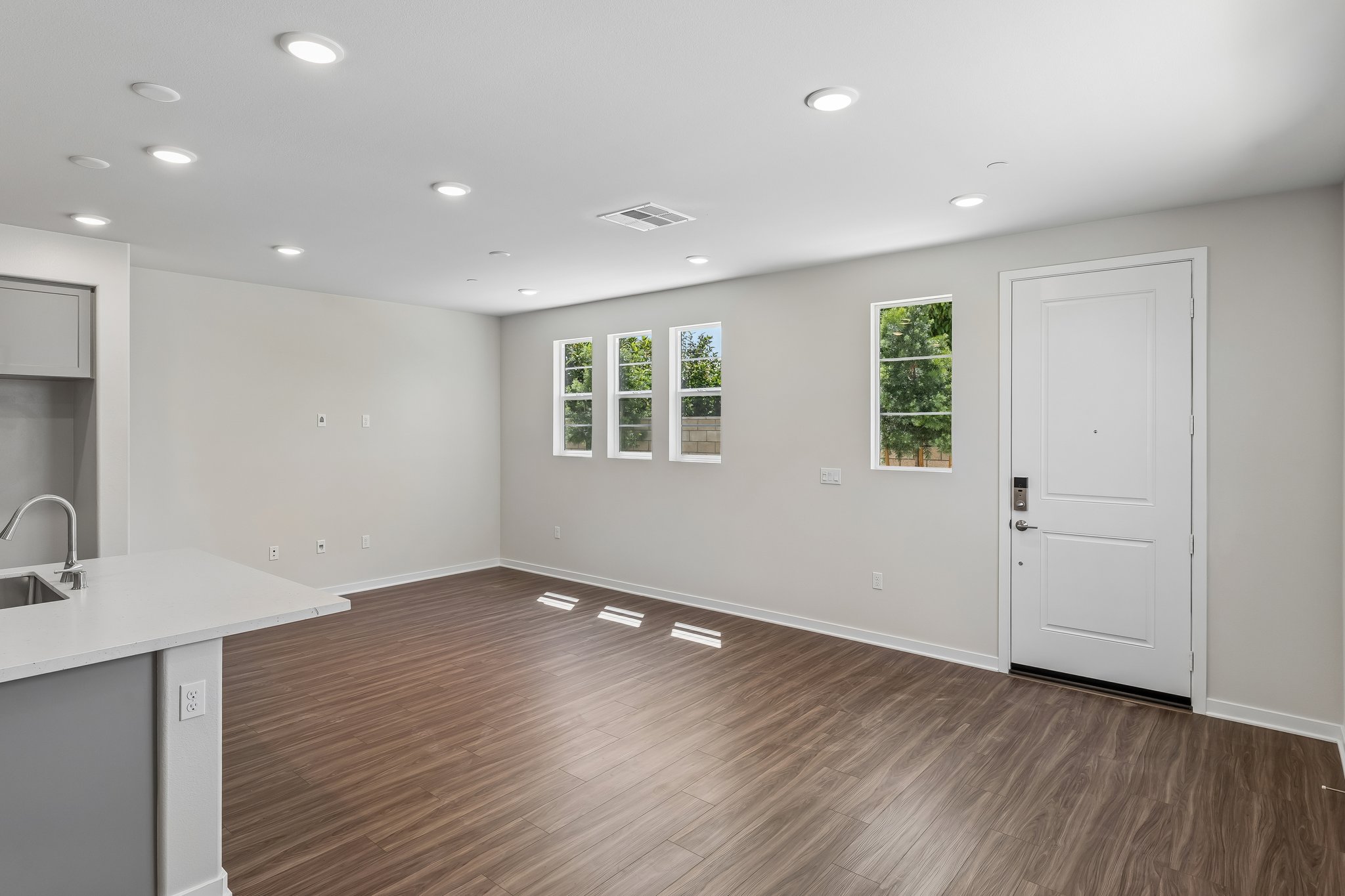 A kitchen with white cabinets.
