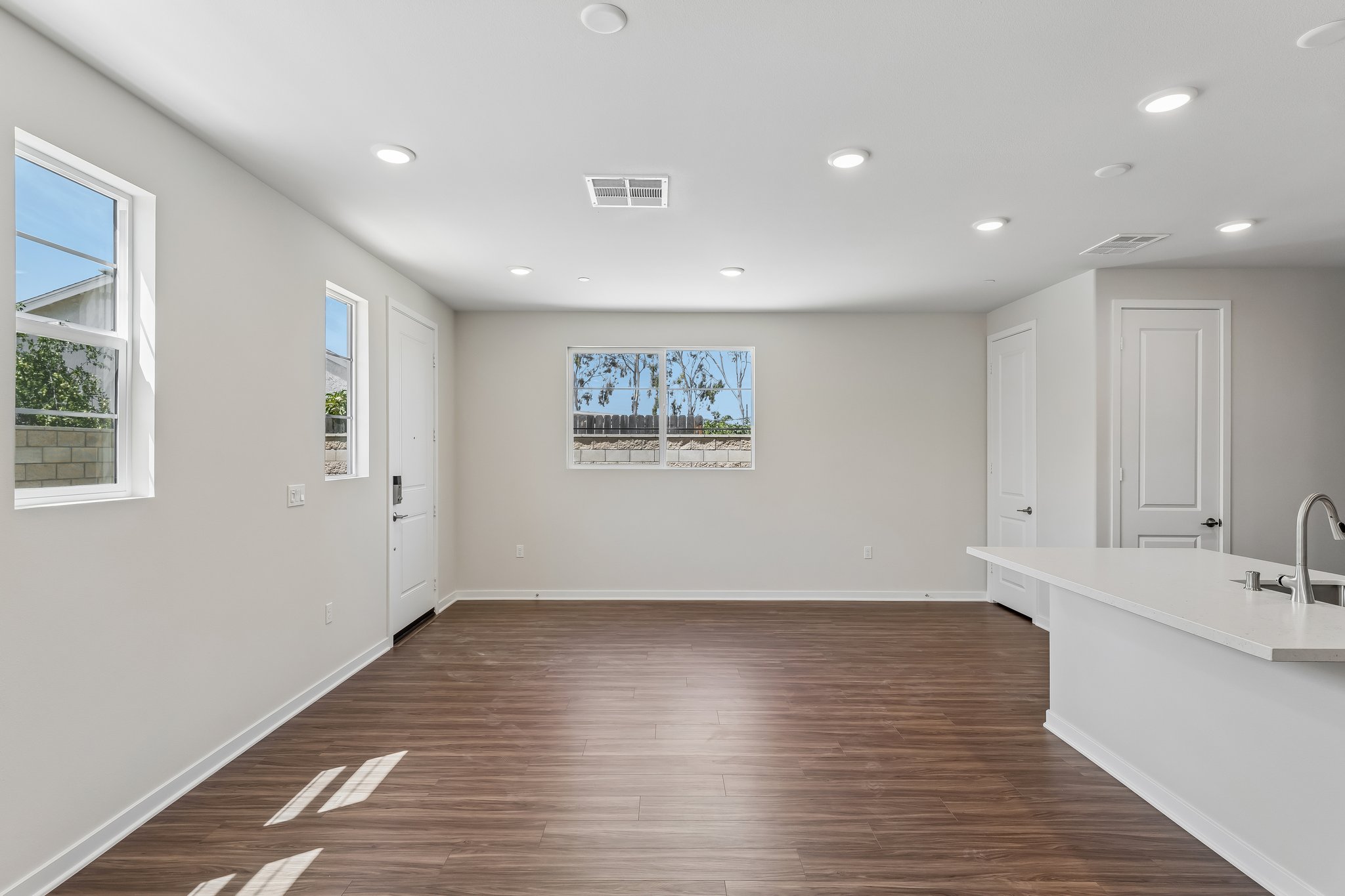 A large bathroom with a wood floor.