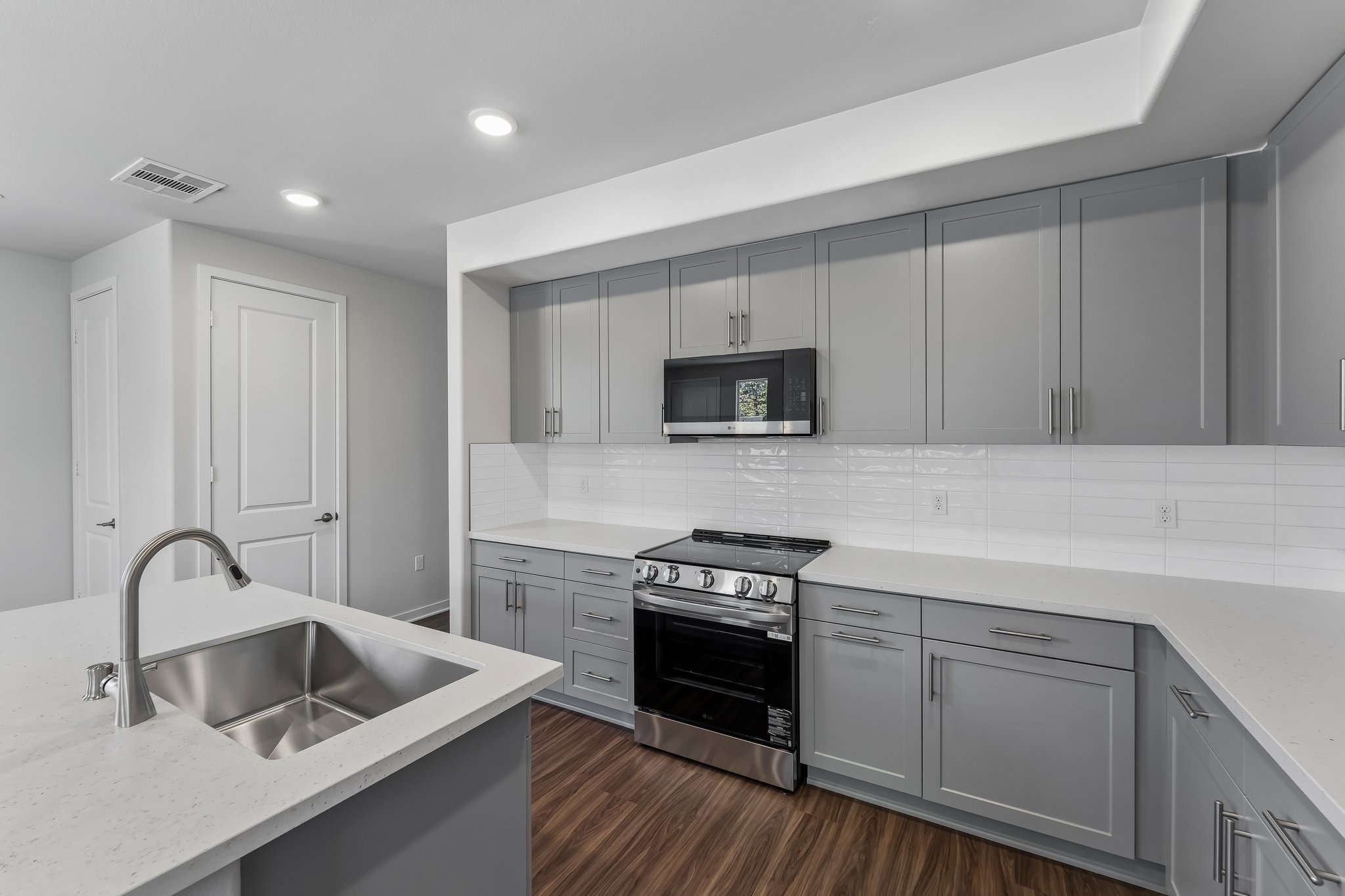 A kitchen with white cabinets.