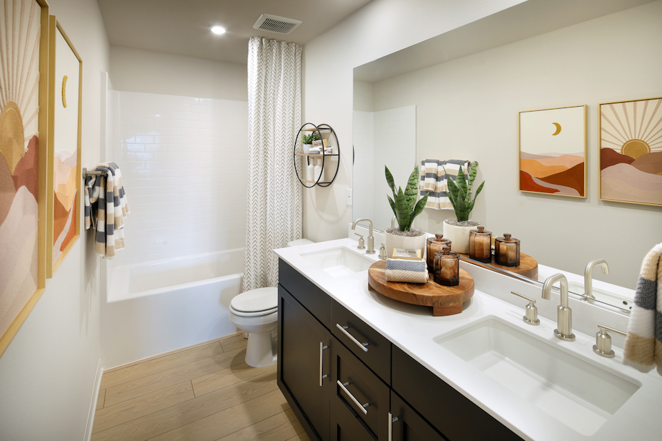 A bathroom with a tub sink and toilet.