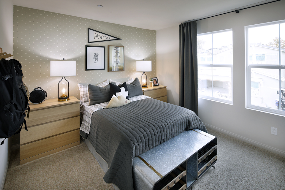 A bedroom with a bed and a bench.