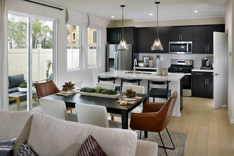 A kitchen with a dining table and chairs.