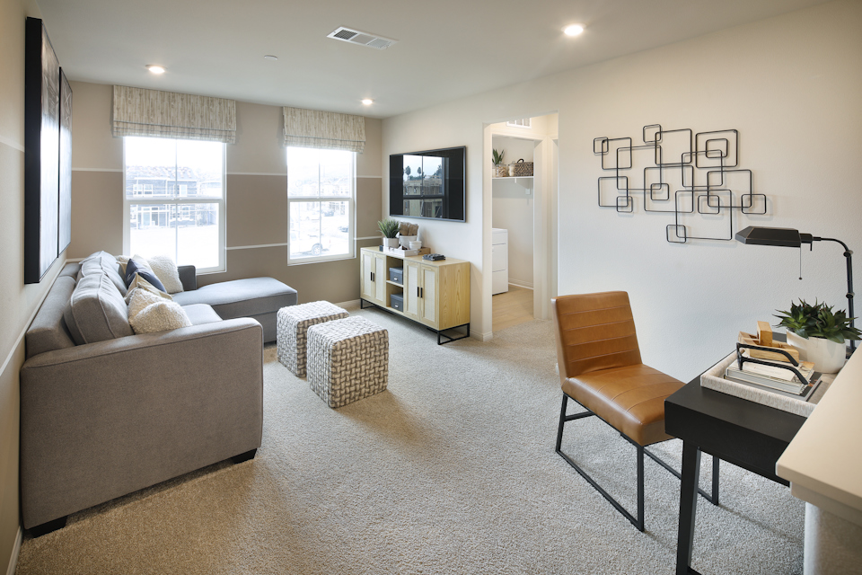 A living room with a couch and a tv.