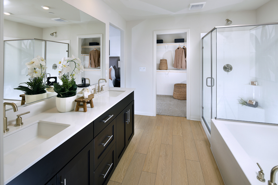 A bathroom with a white countertop and a white bathtub.