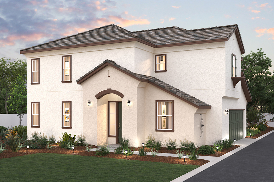 A white house with a lawn.