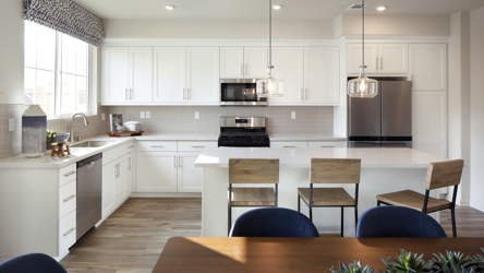 A kitchen with white cabinets.
