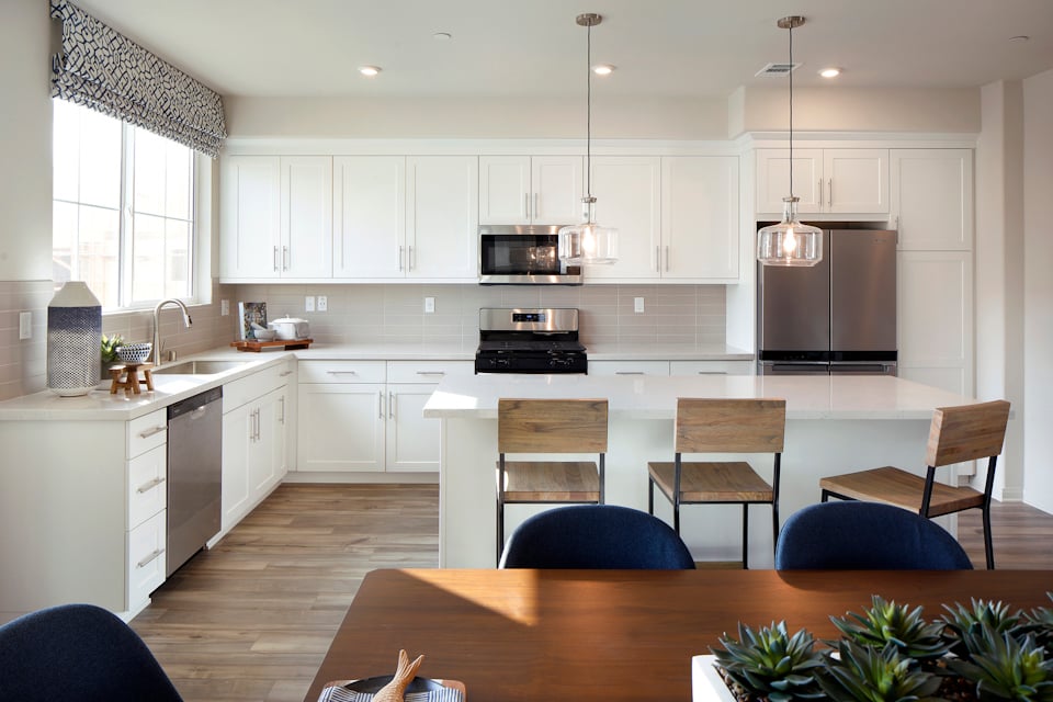 A kitchen with white cabinets.