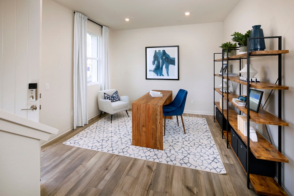 A living room with a table and chairs.