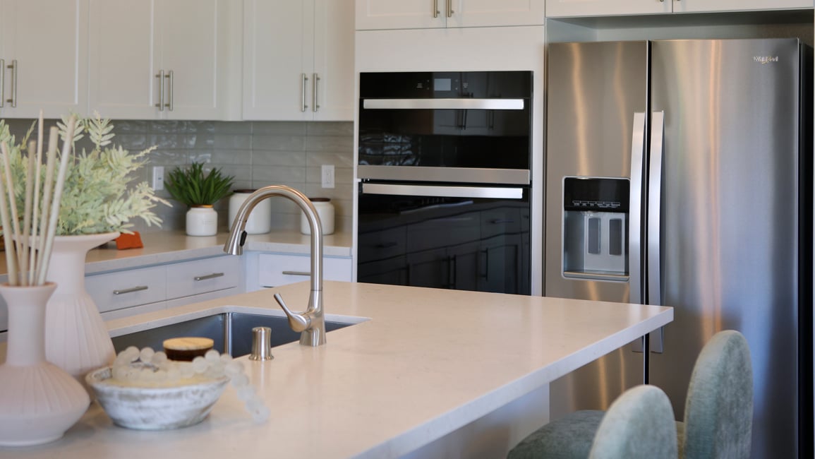 A kitchen with white cabinets.