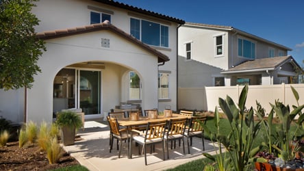 A patio with a table and chairs.
