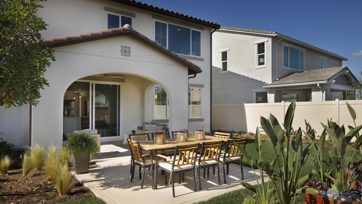A patio with a table and chairs.