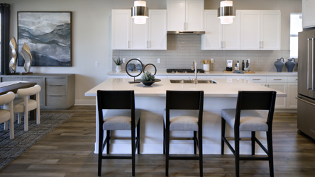 A kitchen with a dining table and chairs.