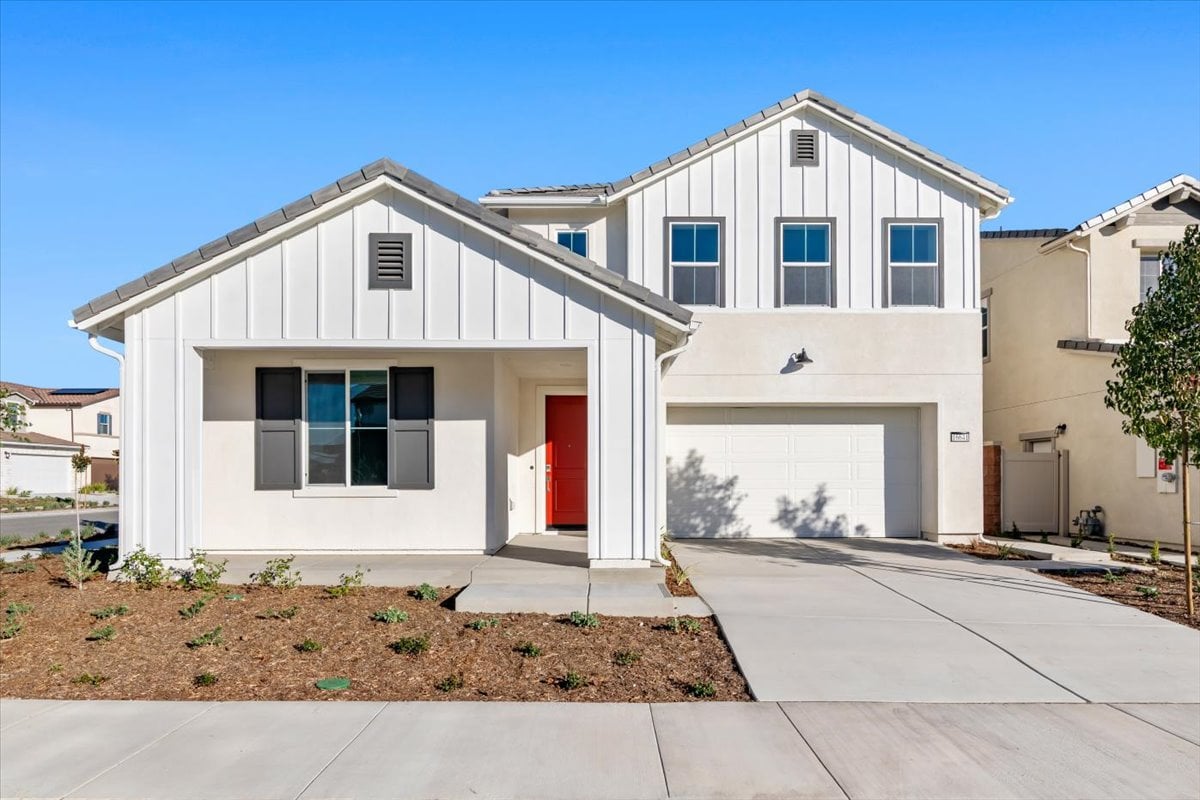 A white house with a red door.
