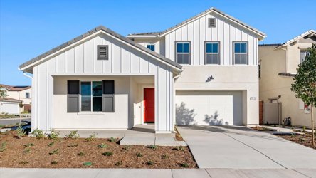 A white house with a red door.