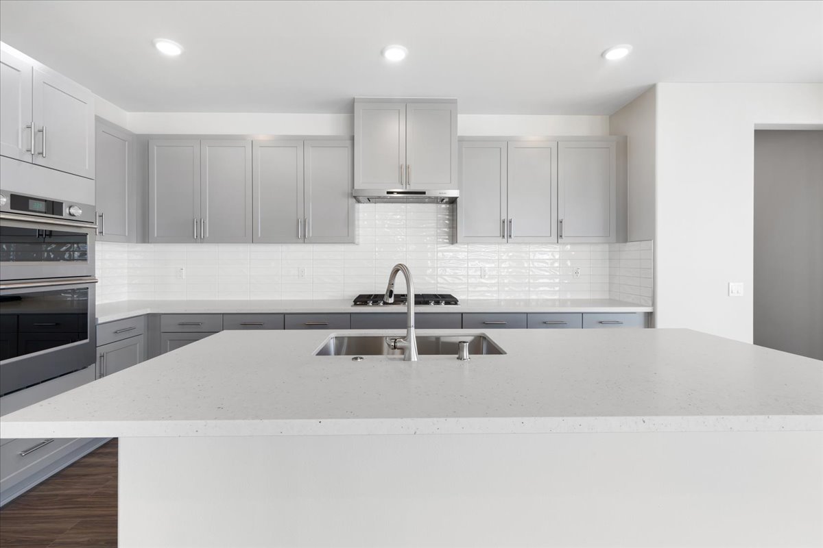 A kitchen with white cabinets.