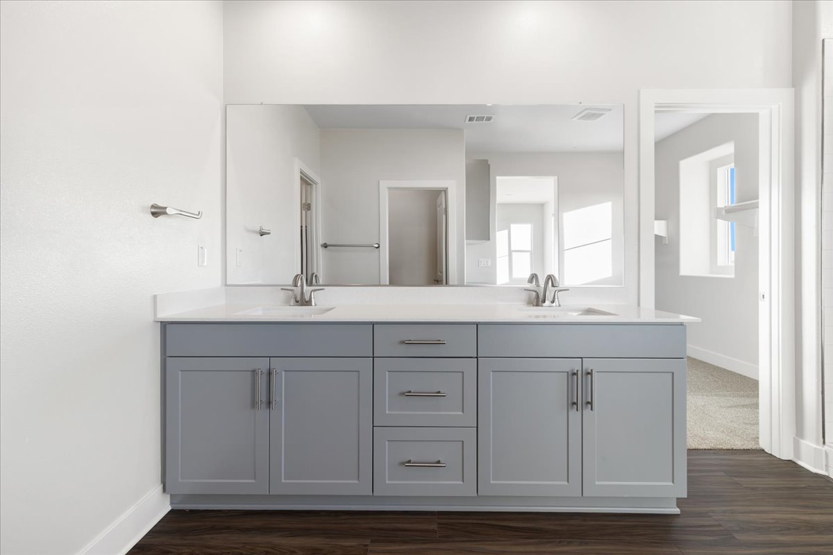 A bathroom with white cabinets.