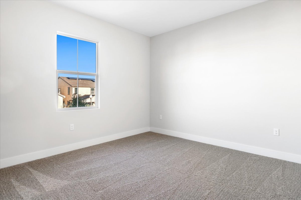 A room with a window and a carpet.