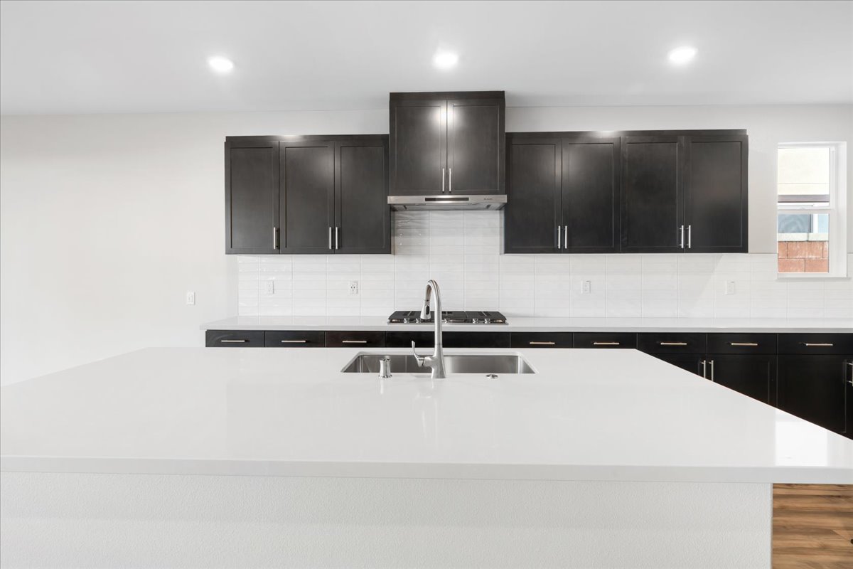 A kitchen with black cabinets.