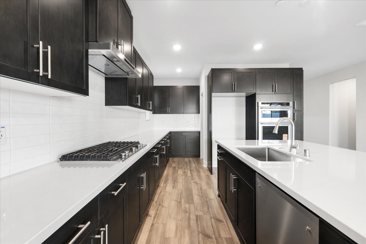 A kitchen with black cabinets.