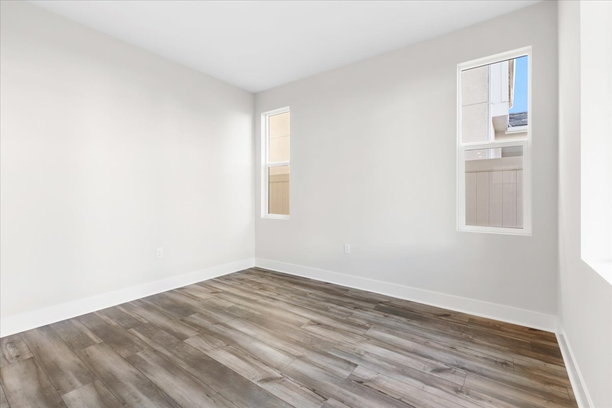 A room with a wood floor and a window.
