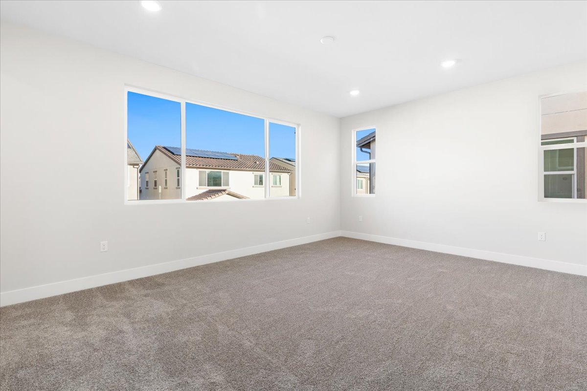 A room with a window and a carpet.