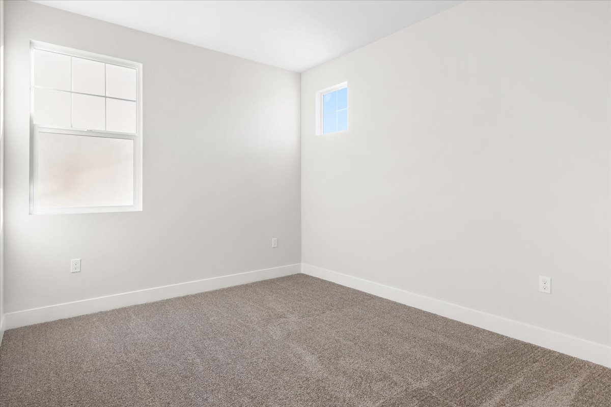 A room with a window and a carpet.