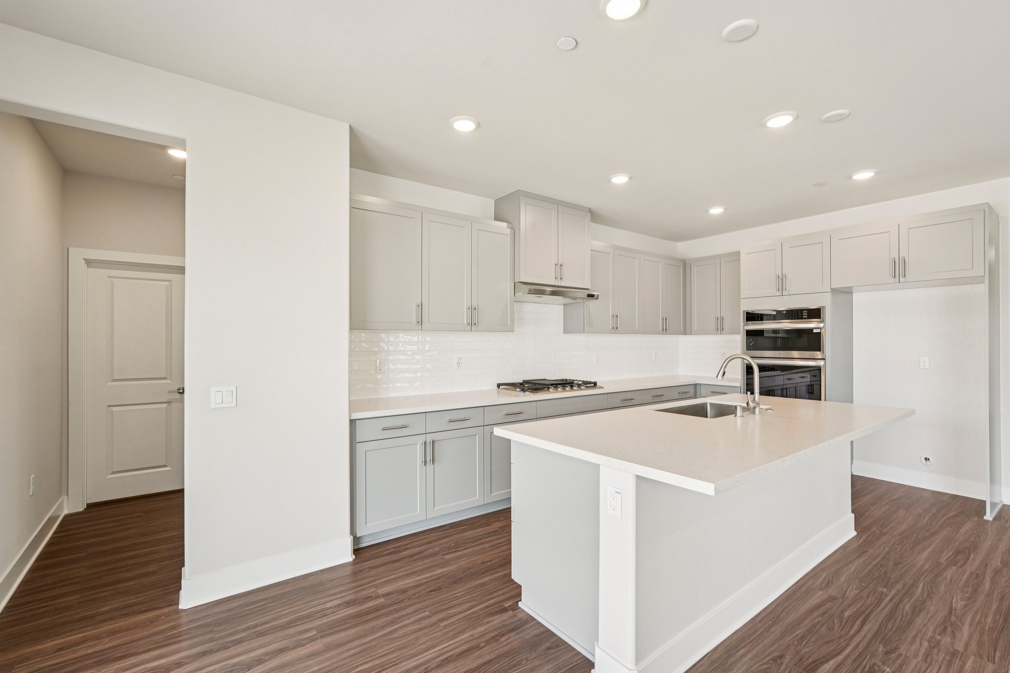 A kitchen with white cabinets.