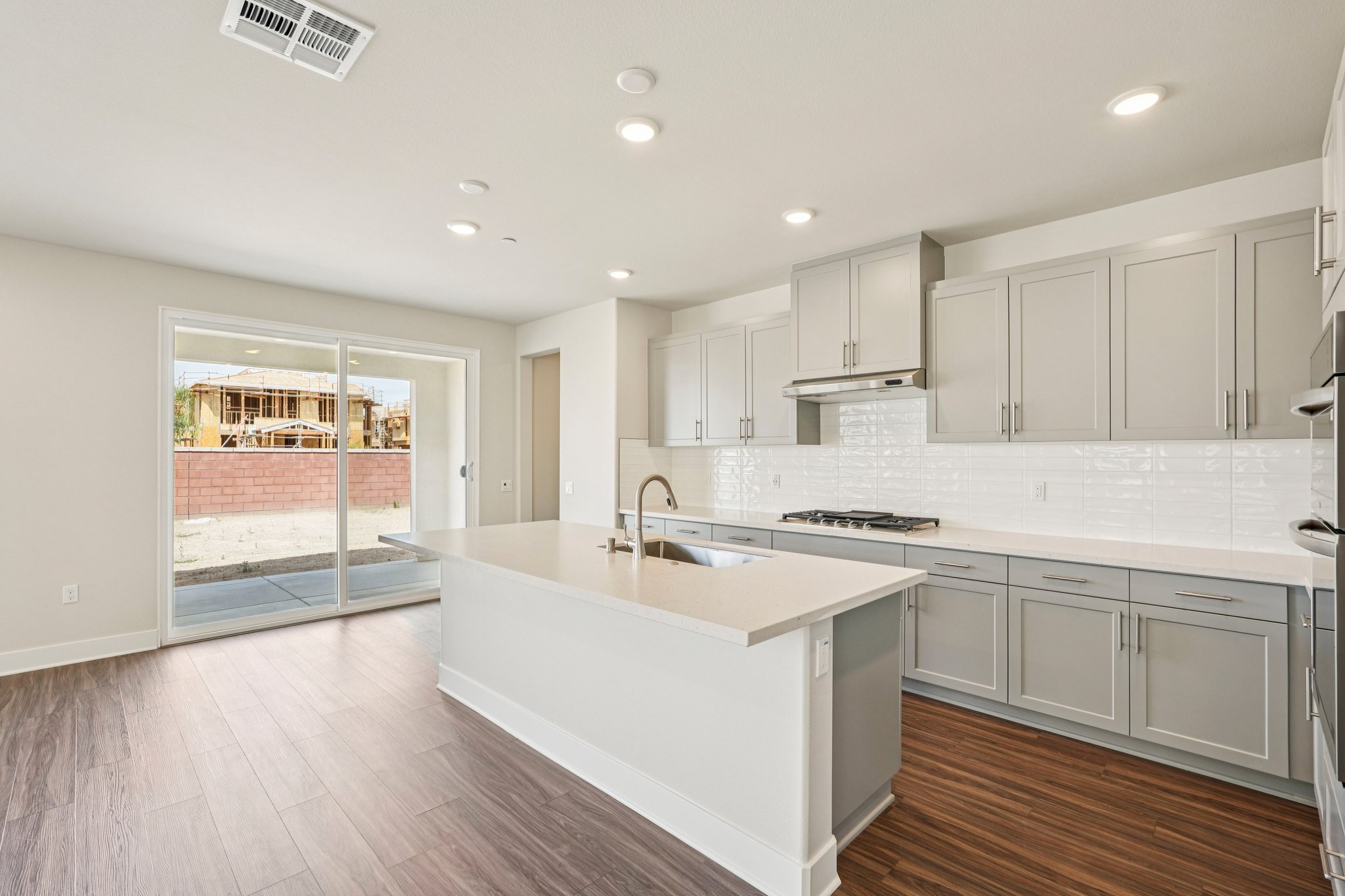 A kitchen with white cabinets.
