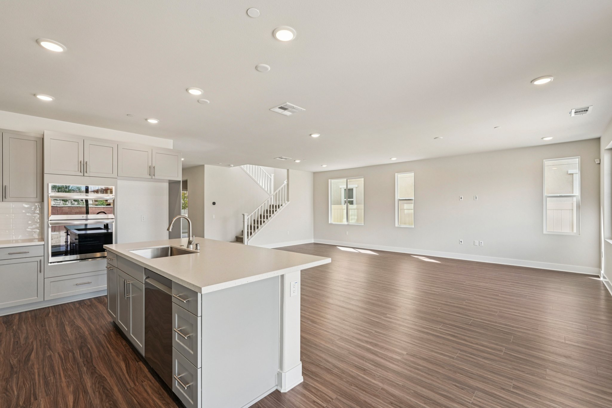A kitchen with white cabinets.
