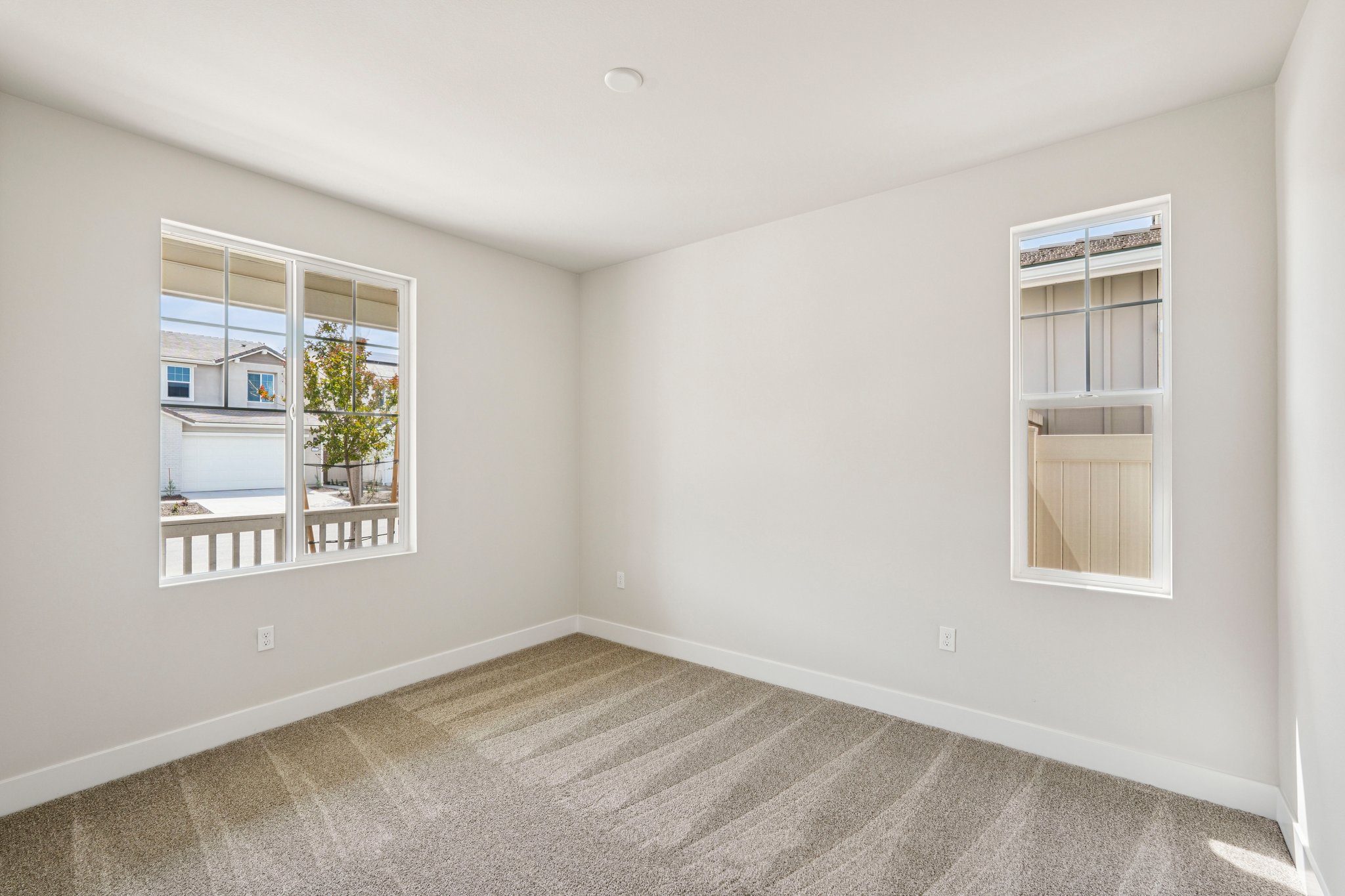 A room with a window and a rug.
