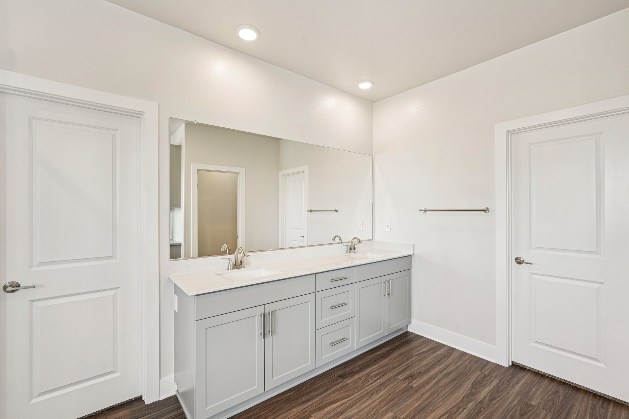 A bathroom with white cabinets.