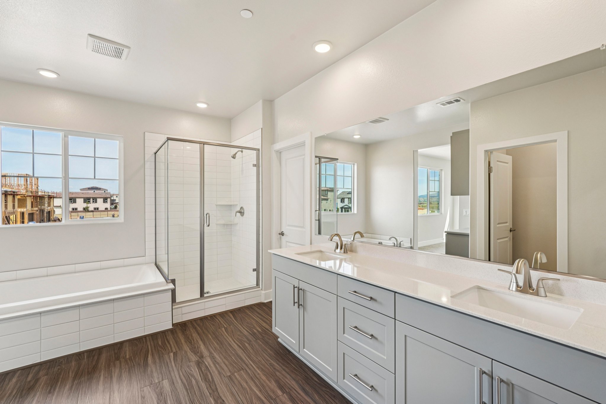 A bathroom with white cabinets.