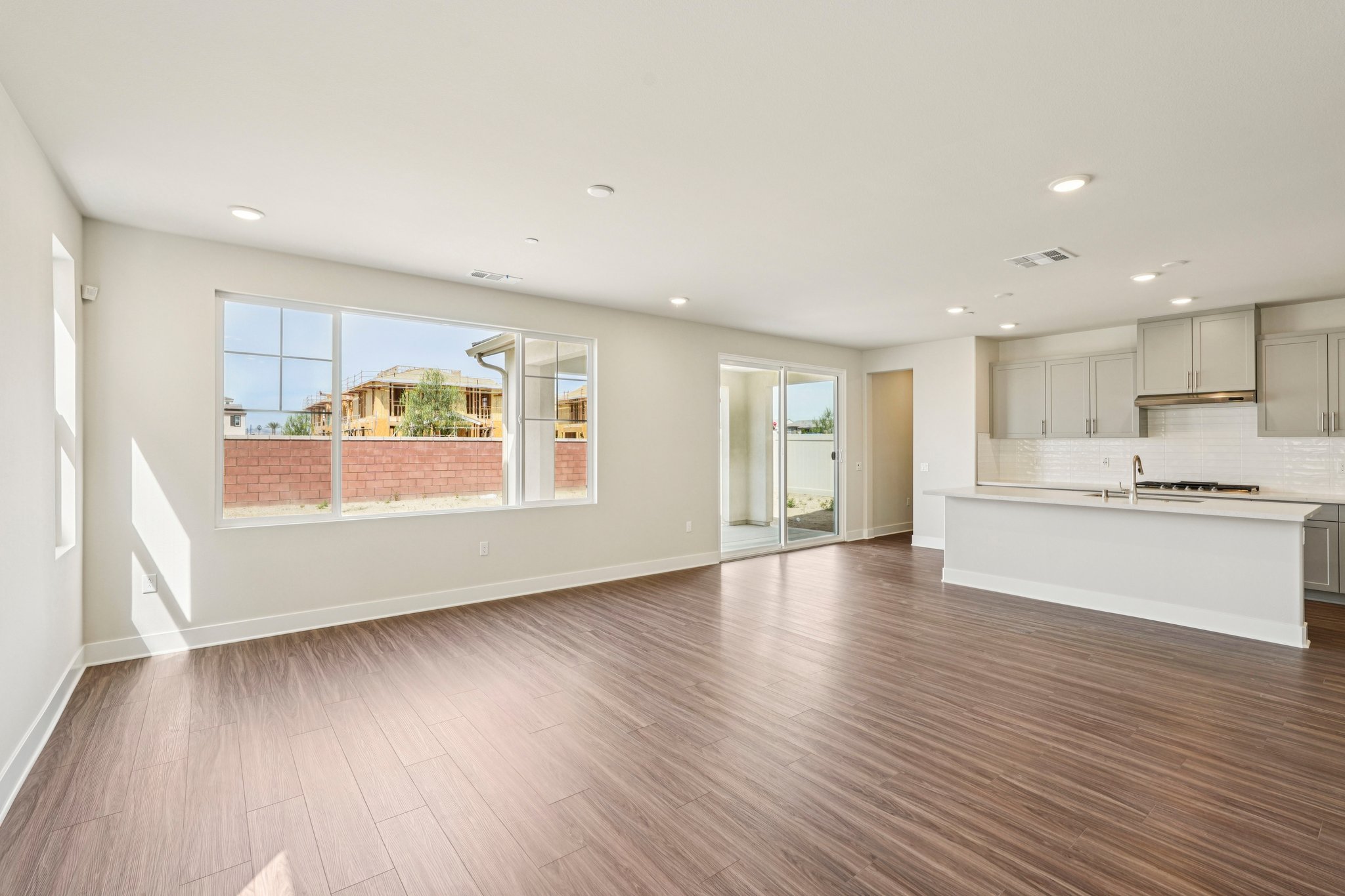 A kitchen with a wood floor.
