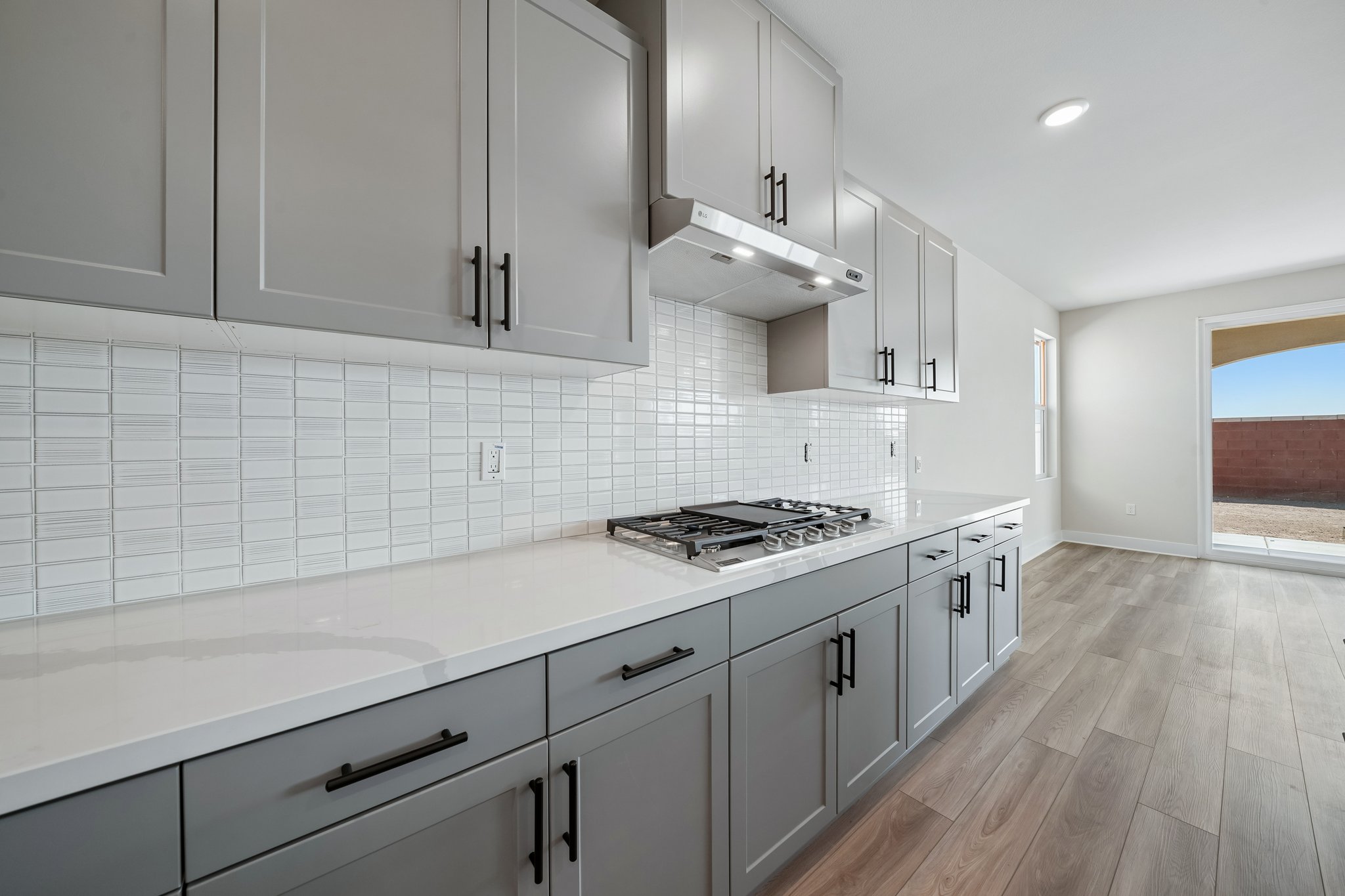 A kitchen with white cabinets.